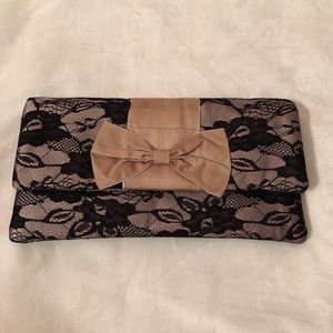 Percy beige and black lace clutch with bow